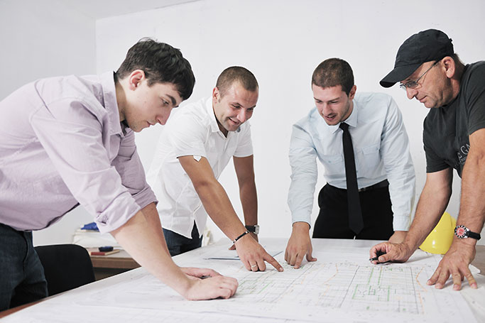Team Meeting Over Blueprints