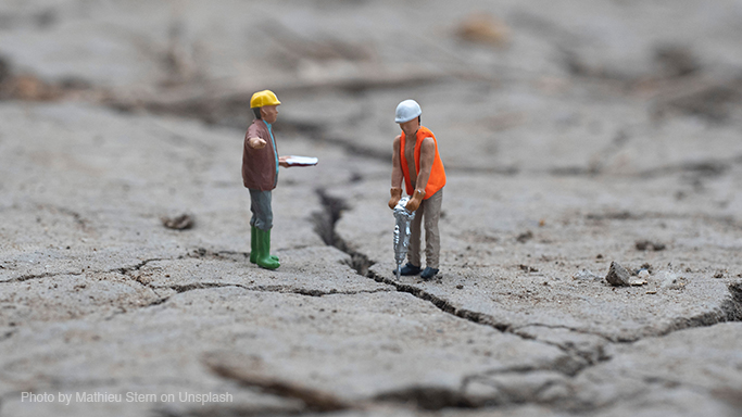 Toy Workers on a dry concrete landscape