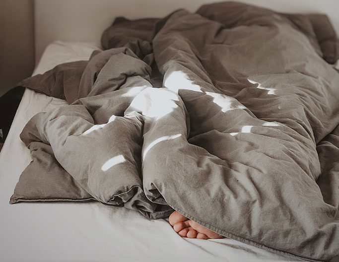 Person sleeping in a bed