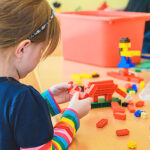 Little Girl Playing with Legos